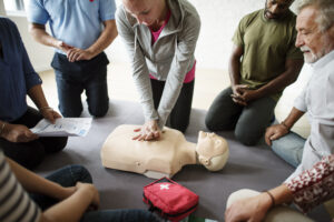 A group doing CPR training - First Aid At The Workplace 