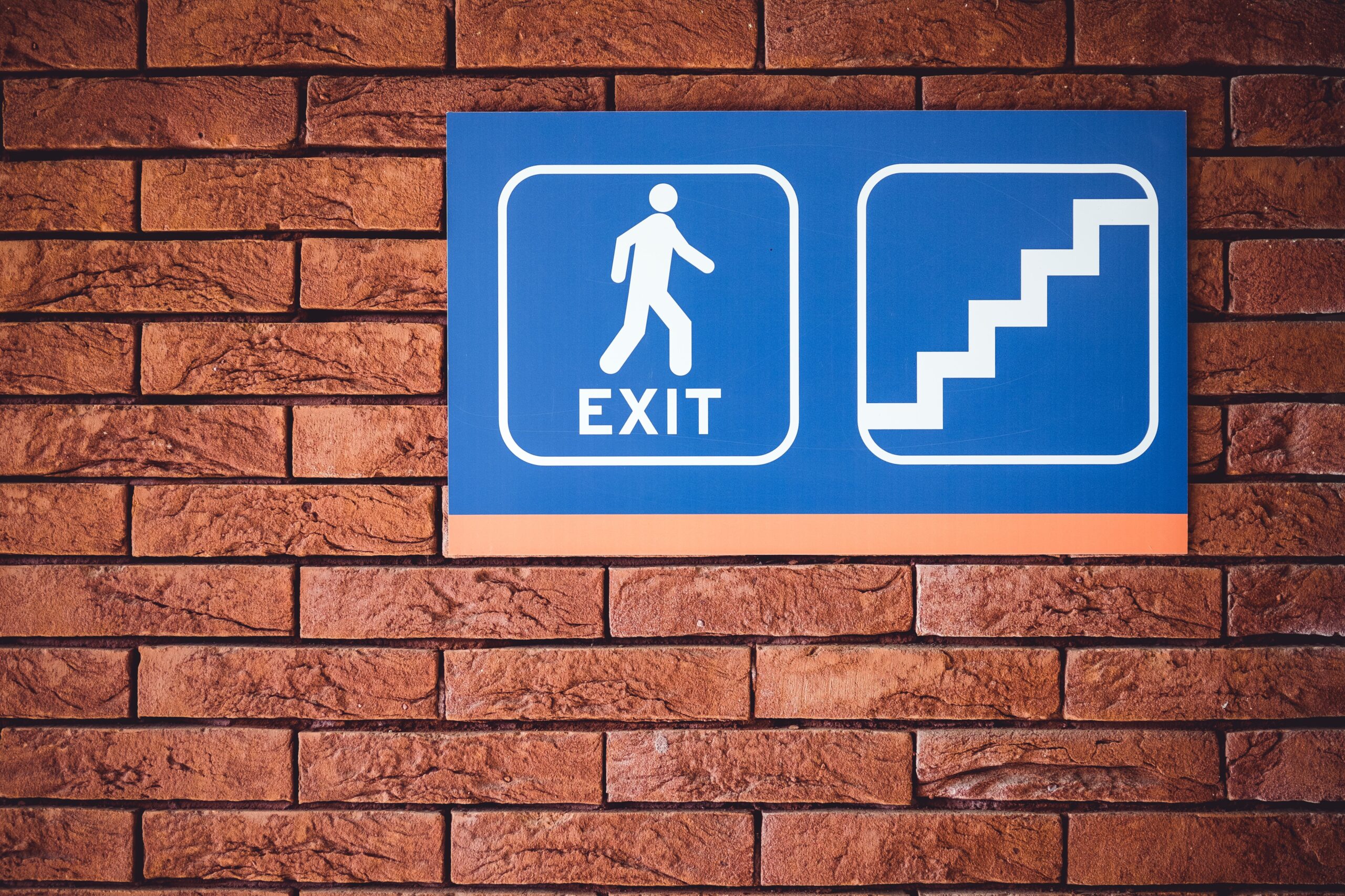 Fire exit sign on wall | Fire Safety in Workplace | Franklins Training Services