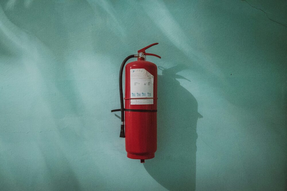 Fire extinguisher on the wall | Fire Safety in the Workplace | Franklins Training Services